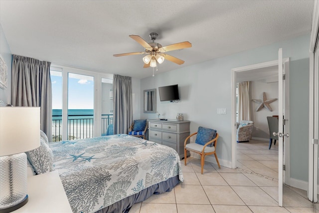 bedroom featuring light tile patterned floors, a textured ceiling, access to outside, and ceiling fan