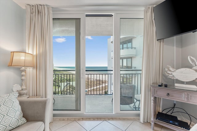 entryway featuring light tile patterned flooring and a water view