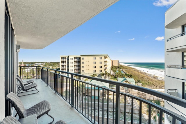 balcony with a water view and a beach view