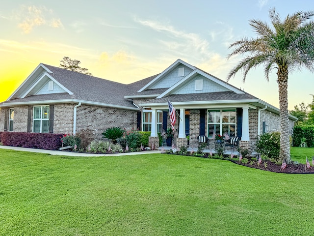 craftsman-style house with covered porch and a lawn