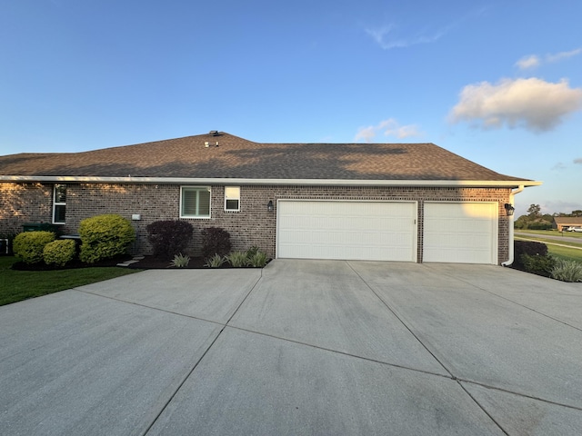 624 Tournament Ln, Freeport, FL 32439 - view of front of home featuring a garage, brick siding, driveway, and roof with shingles