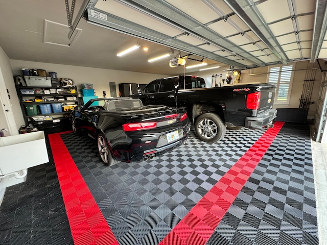 garage with a garage door opener and a carport