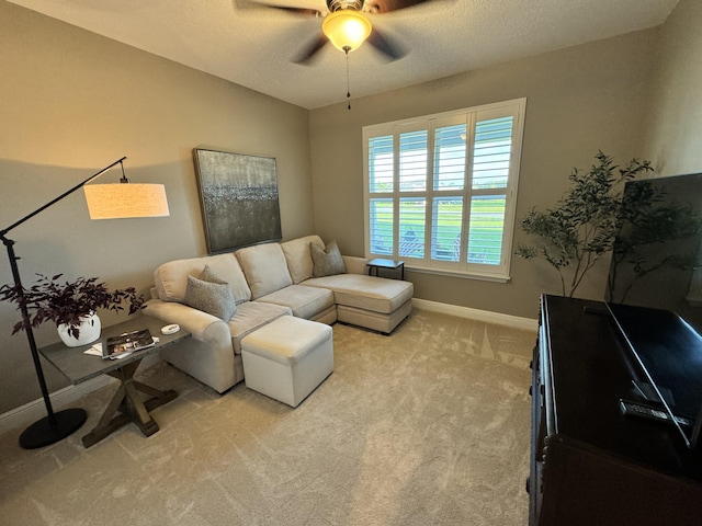 624 Tournament Ln, Freeport, FL 32439 - living room featuring a ceiling fan, baseboards, light colored carpet, and a textured ceiling