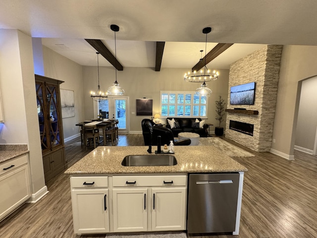 624 Tournament Ln, Freeport, FL 32439 - kitchen featuring dishwasher, open floor plan, wood finished floors, a sink, and beamed ceiling