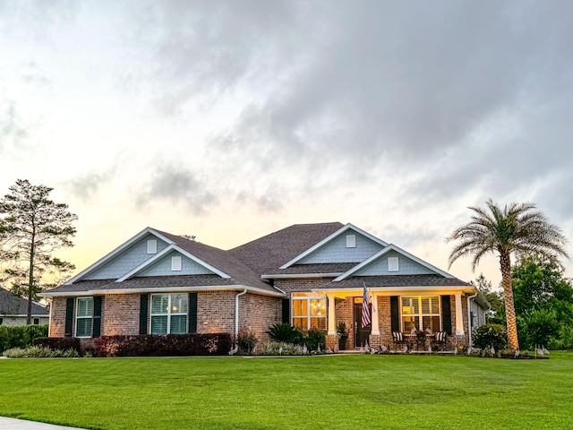 624 Tournament Ln, Freeport, FL 32439 - craftsman inspired home featuring brick siding, a lawn, and covered porch