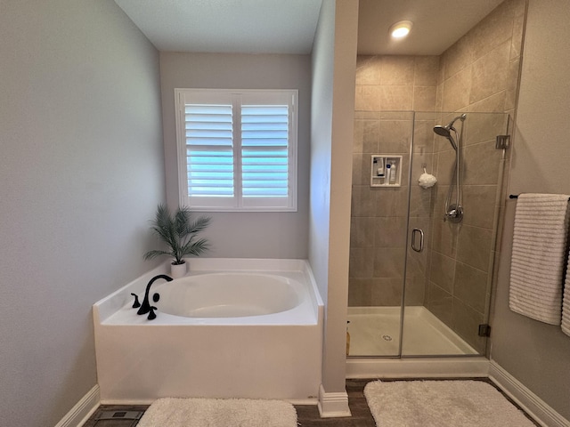 624 Tournament Ln, Freeport, FL 32439 - full bathroom with a bath, a shower stall, and baseboards