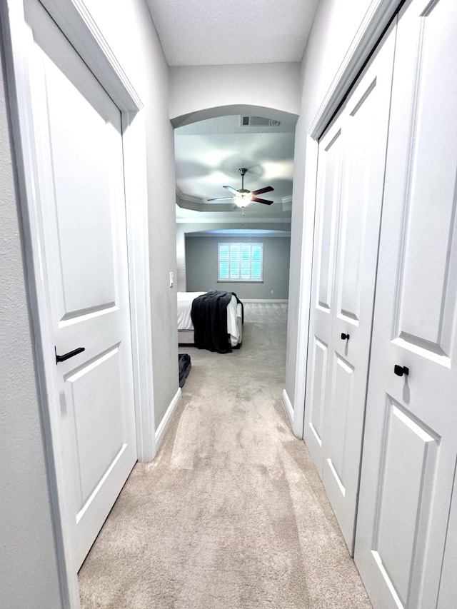 624 Tournament Ln, Freeport, FL 32439 - hall featuring light colored carpet, baseboards, and arched walkways