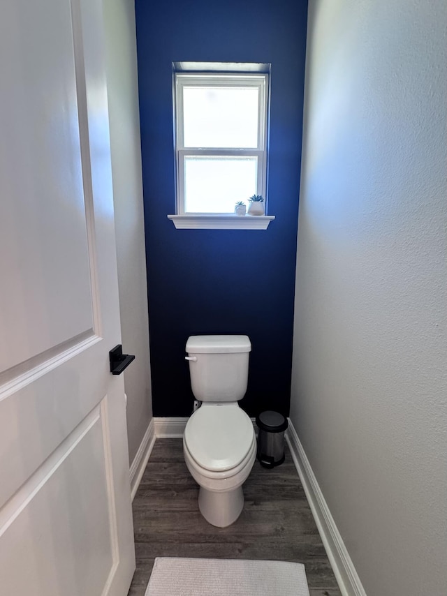 624 Tournament Ln, Freeport, FL 32439 - bathroom with wood finished floors, toilet, and baseboards