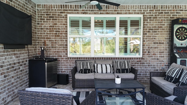 view of patio with an outdoor living space and ceiling fan