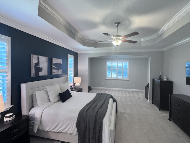 624 Tournament Ln, Freeport, FL 32439 - bedroom with a raised ceiling, light carpet, crown molding, a ceiling fan, and baseboards