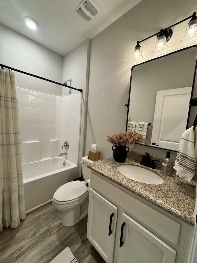 624 Tournament Ln, Freeport, FL 32439 - full bathroom with vanity, wood finished floors, toilet, and shower / bath combo