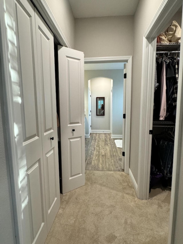 624 Tournament Ln, Freeport, FL 32439 - hallway featuring arched walkways, carpet floors, and baseboards