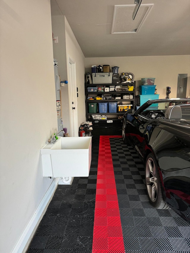 garage featuring sink and electric panel