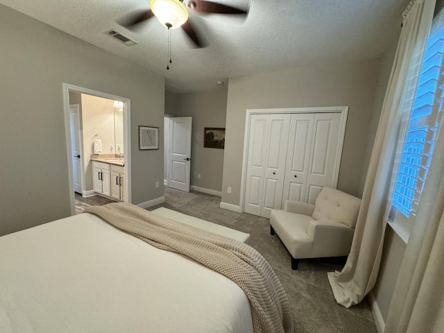 624 Tournament Ln, Freeport, FL 32439 - bedroom with a textured ceiling, carpet floors, baseboards, a closet, and ceiling fan