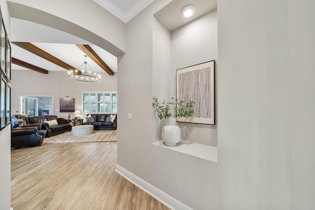 624 Tournament Ln, Freeport, FL 32439 - hall featuring baseboards, wood finished floors, a chandelier, beam ceiling, and a high ceiling