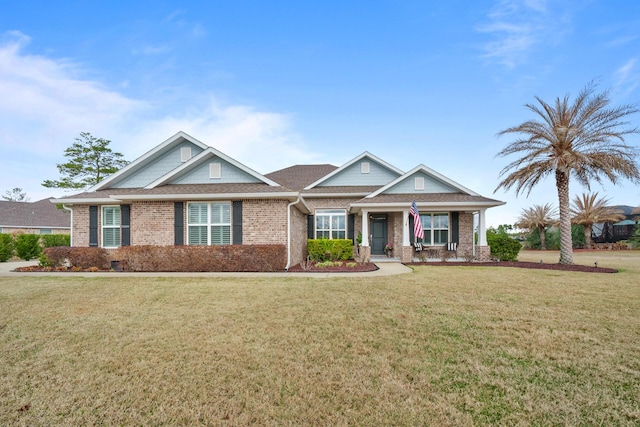 craftsman-style house with a front yard and covered porch