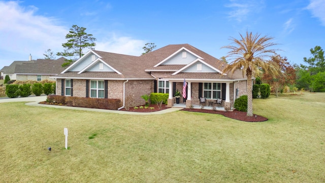 624 Tournament Ln, Freeport, FL 32439 - craftsman house with brick siding, a front yard, covered porch, and roof with shingles