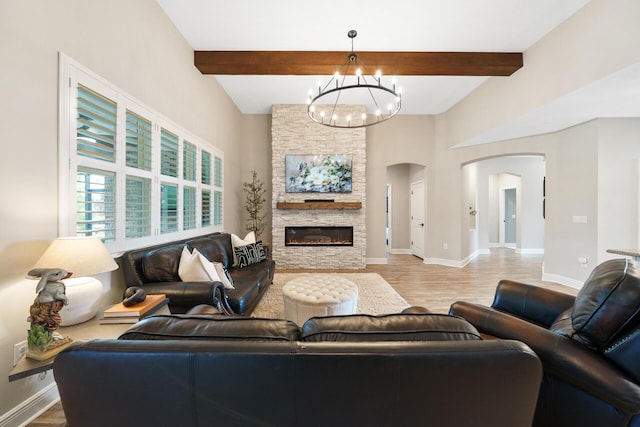 624 Tournament Ln, Freeport, FL 32439 - living room with arched walkways, a chandelier, wood finished floors, beam ceiling, and baseboards