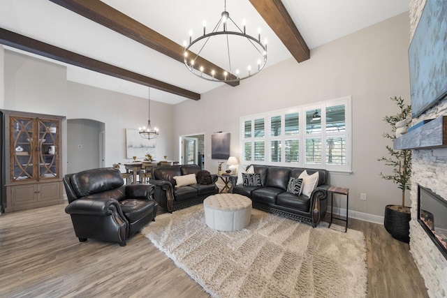 624 Tournament Ln, Freeport, FL 32439 - living area featuring a chandelier, beam ceiling, light wood-type flooring, a high ceiling, and a fireplace