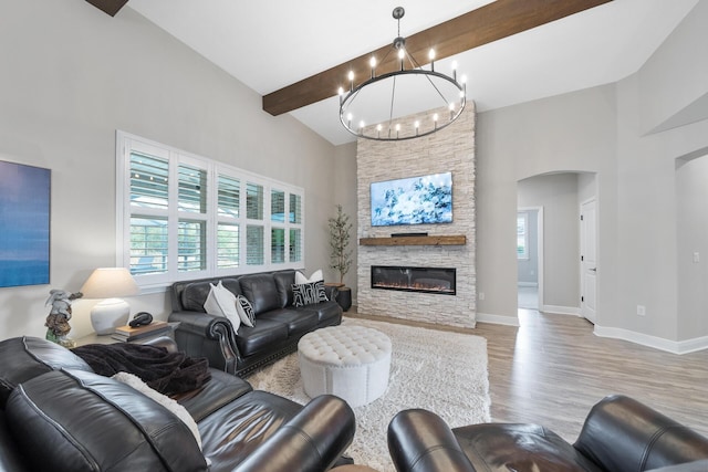 624 Tournament Ln, Freeport, FL 32439 - living room featuring a towering ceiling, a chandelier, arched walkways, beam ceiling, and wood finished floors