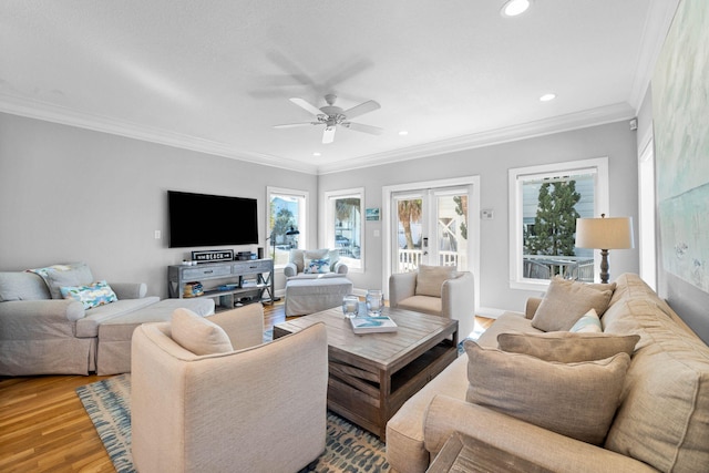 living room featuring ceiling fan, wood-type flooring, ornamental molding, and french doors