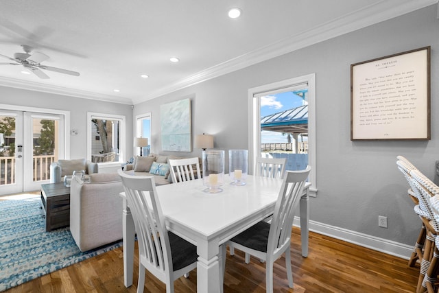 dining space with french doors, dark hardwood / wood-style floors, ceiling fan, and crown molding