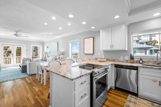 kitchen featuring white cabinets, a wealth of natural light, and appliances with stainless steel finishes