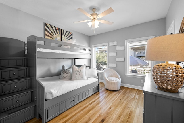 bedroom with light hardwood / wood-style flooring and ceiling fan