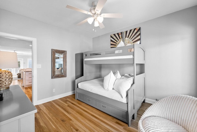 bedroom with light hardwood / wood-style floors and ceiling fan