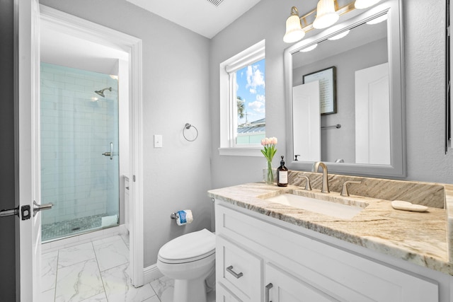 bathroom with vanity, toilet, and a shower with shower door