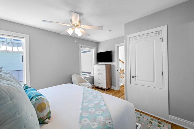 bedroom with ceiling fan and light hardwood / wood-style flooring