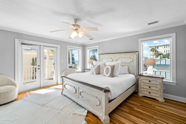 bedroom featuring access to outside, multiple windows, hardwood / wood-style flooring, and ceiling fan