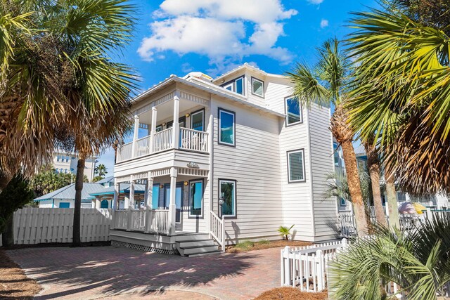 view of front of property featuring covered porch and a balcony