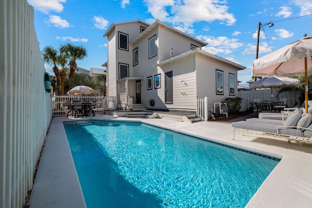 view of swimming pool featuring a patio area and a wooden deck