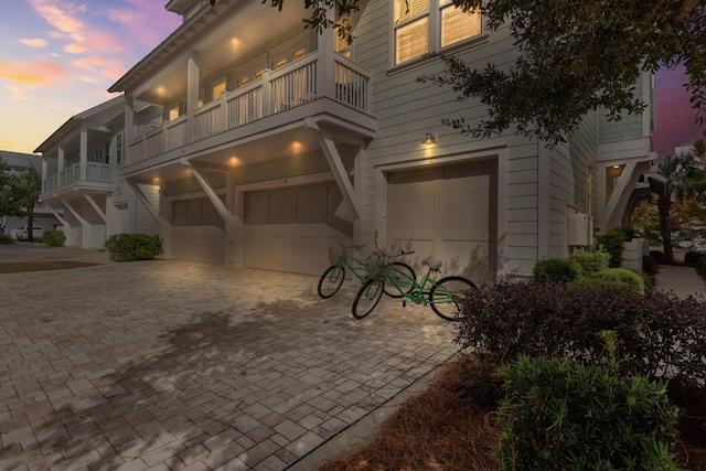 view of front of house featuring a balcony and a garage