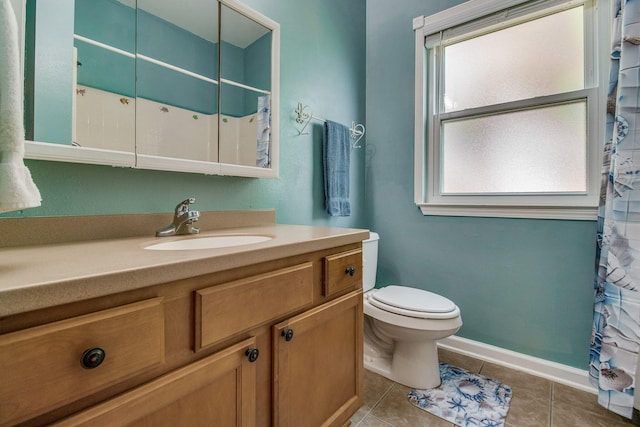 bathroom with tile patterned flooring, vanity, and toilet