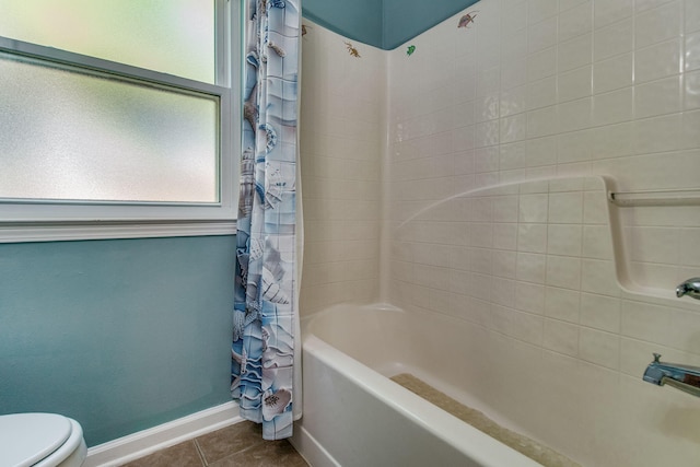 bathroom with tile patterned flooring, shower / bath combo, and toilet