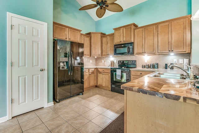 kitchen featuring ceiling fan, sink, black appliances, light tile patterned floors, and butcher block countertops