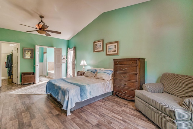 bedroom featuring ensuite bathroom, ceiling fan, lofted ceiling, and light wood-type flooring