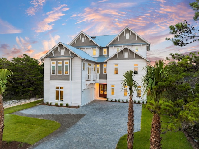 view of front of property featuring a garage and a balcony