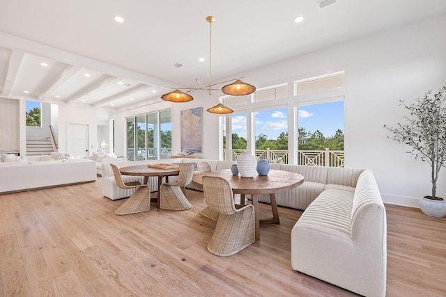 dining space featuring a chandelier and light wood-type flooring