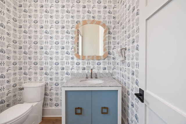 bathroom featuring vanity and toilet