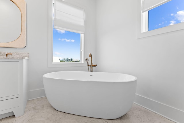 bathroom with vanity and a bath