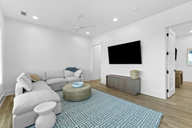 living room featuring ceiling fan and light hardwood / wood-style floors