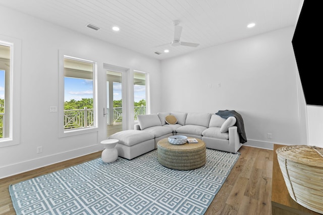 living room featuring light hardwood / wood-style flooring, ceiling fan, and wooden ceiling