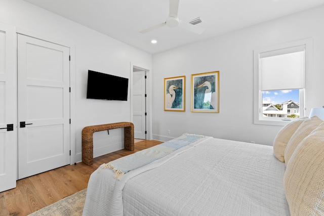 bedroom with light wood-type flooring and ceiling fan