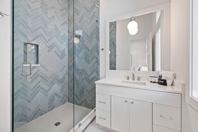 bathroom with tile patterned flooring, vanity, and a shower with door