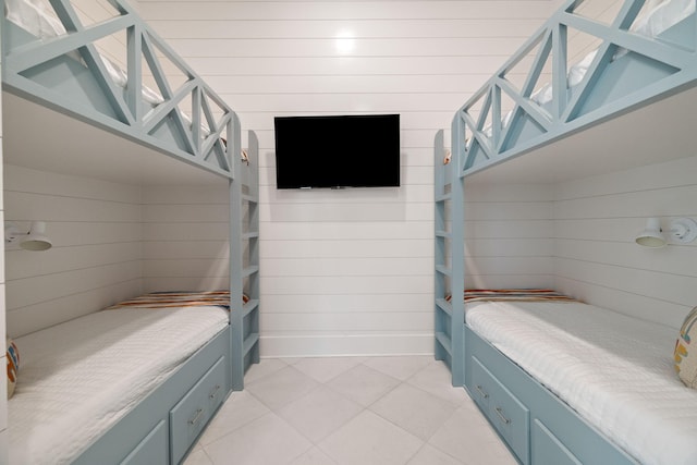 bedroom featuring wooden walls