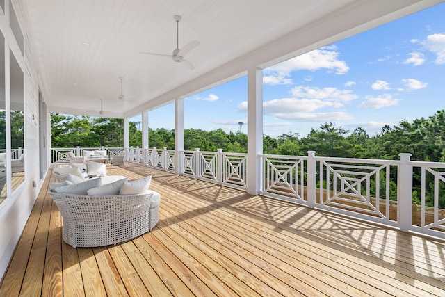 wooden terrace featuring outdoor lounge area and ceiling fan