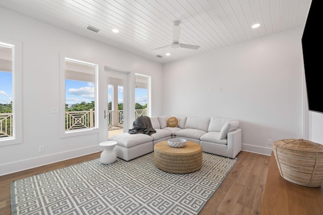 living room featuring ceiling fan, wooden ceiling, and light hardwood / wood-style flooring